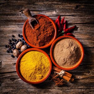 Indian spices background: cinnamon powder, paprika and turmeric