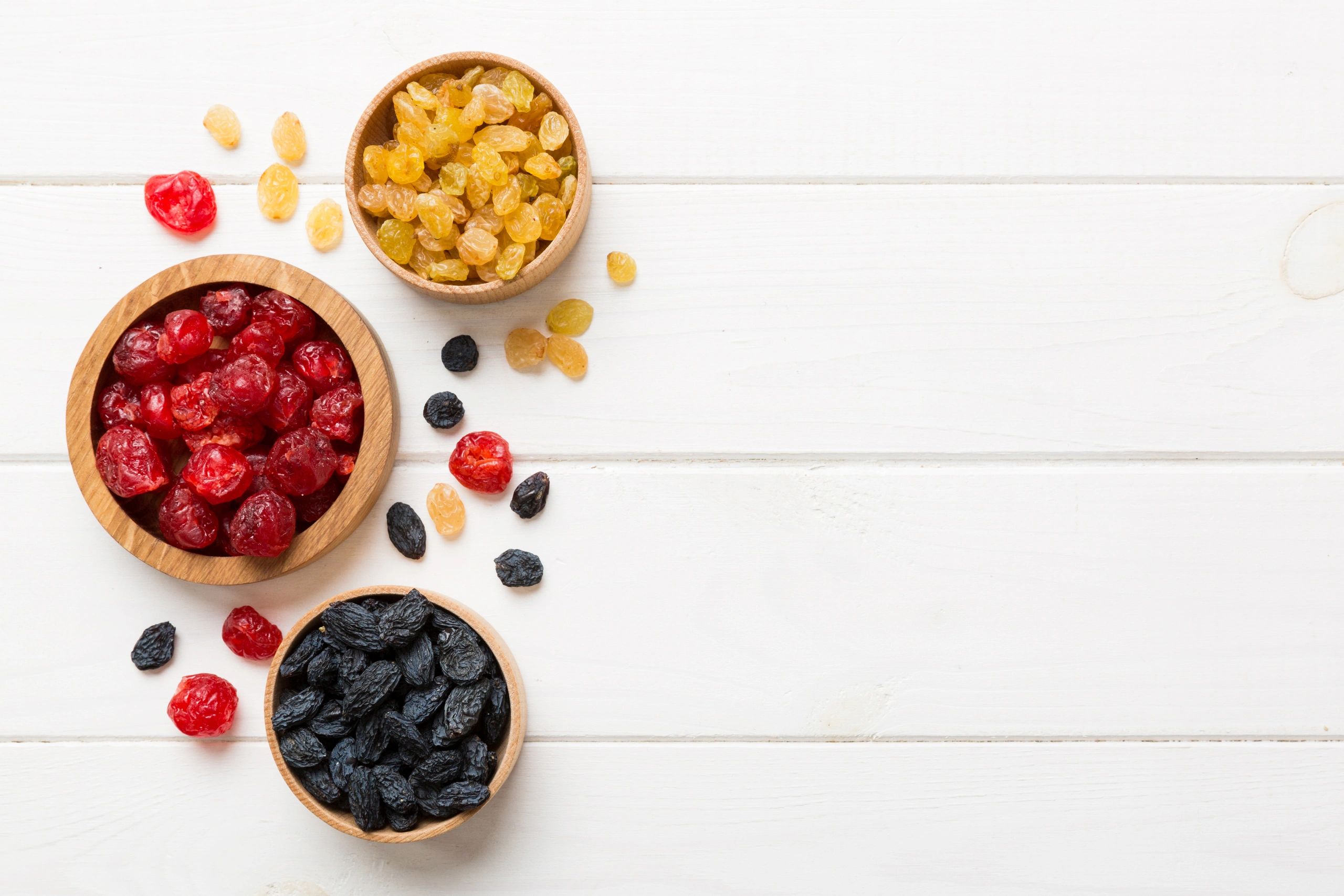 Assorted dried fruits in bowls viewed from above