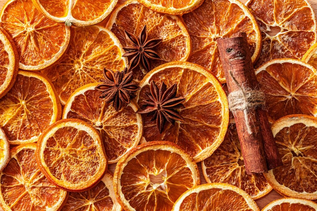 Scented dehydrated orange slices, star anise and cinnamon sticks background